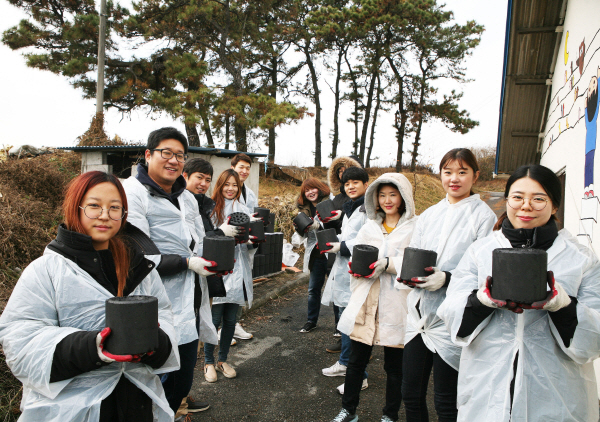 삼성디스플레이 임직원들이 지난 달 30일 천안시 성환읍에서 겨울나기를 위한 '행복연탄 나눔' 봉사활동을 하고 있다. <사진=삼성디스플레이>