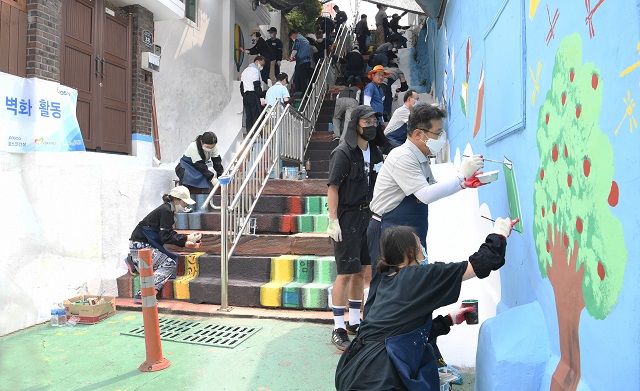 포스코건설 임직원들이 인천 동구 배다리마을 벽화그리기 봉사를 실시하는 모습 <사진=포스코건설>