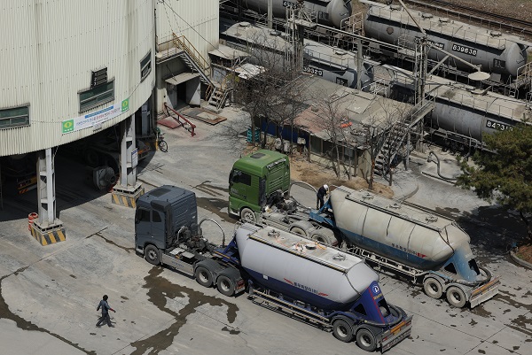 러시아의 우크라이나 침공 사태로 인해 시멘트 등 건설자재 수급 불안이 커지고 있다. 서울시내 한 시멘트공장에 시멘트 수송을 위한 화물트럭과 열차가 세워져 있는 모습. <사진=연합>